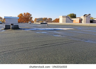 Building with newly renovated flat roof sealing