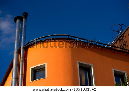 building with orange facade with round corner