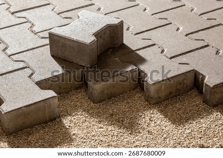 Building an pedestrian path with paver bricks. Sidewalk pavement. Process of laying interlocking concrete paving stones on a gravel base