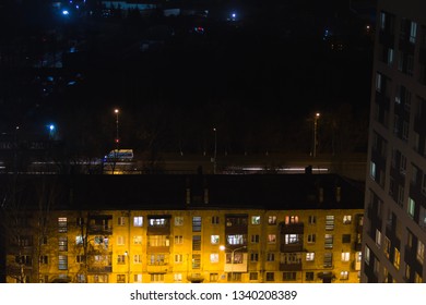 Building With People Silhouettes In Windows. Casual Urban City Life. Traffic On The Road. People Waite Bus On Busstop With Traffic Light. Aerial Panoramic View From Tower Rooftop.