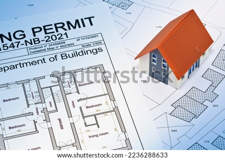 Building Permit concept with imaginary building approvation and residential home against a cadastral map and General Urban Planning 