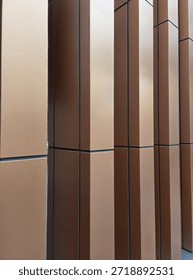 Building pillars with copper colored cladding