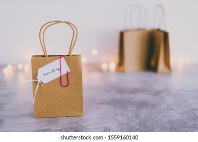 building a recognizable brand conceptual still-life, shopping bag with Branding text on price tag and other plain bags in the background shot at shallow depth of field (bokeh) with fairy lights - Shutterstock ID 1559160140