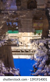 building reflected in a puddle