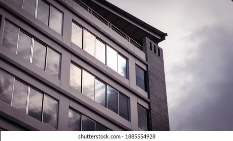 building with reflection of the sky in its windows