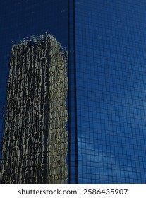 Building in a building. Reflection of skyscraper on a second skyscraper
