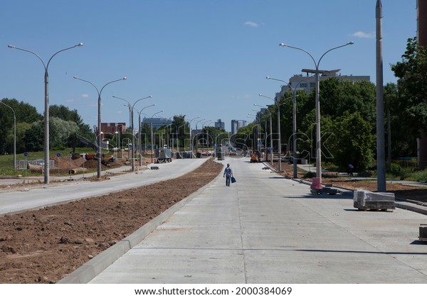 Building, repairing a concrete road and\
sidewalk in the city. Minsk, Belarus.\
06.17.2021.