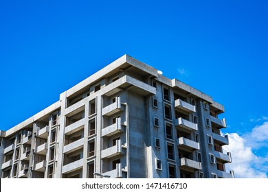 Building shell made of concrete of a huge apartment building with many accomodations under blue sky
