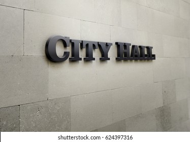 A building signage that says 'City Hall'.