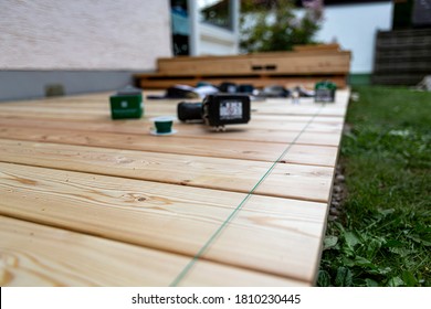 Building Site - Laying Larch Floorboards On A Terrace. Installing Of Siberian Larch Flooring.