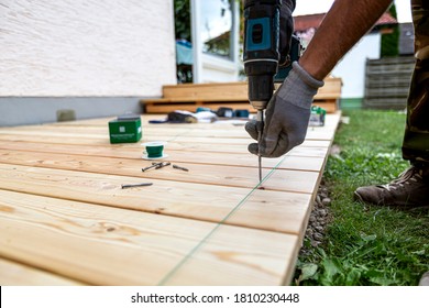 Building Site - Laying Larch Floorboards On A Terrace. Installing Of Siberian Larch Flooring.