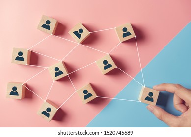 Building A Strong Team, Wooden Blocks With People Icon On Blue And Pink Background, Human Resources And Management Concept.