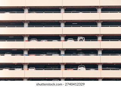 Building structure with multiple levels of parked cars creating a repeating pattern