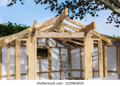 Building summer house or shed in the garden, wooden structure, waterproofed, on a stone base, selective focus