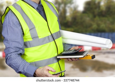 Building Surveyor In Hi Vis Carrying Site Plans And Calculator