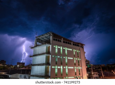 Building with thunder storms back ground at the night 