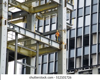 Building Under Construction With Climber Worker.