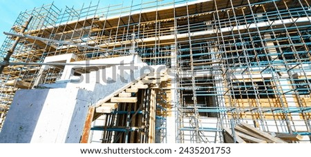 A building under construction with scaffolding and a staircase. The building is in the process of being built and is not yet finished ストックフォト © 