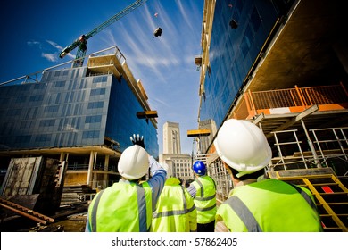 building under construction and workers