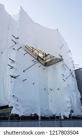 Building Under Construction Wrapped In A White Synthetic Plastic Wrap