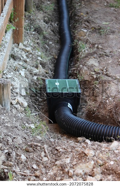 Building an
Underground French Drain System after Digging the trench system to
keep water away from home's
foundation.