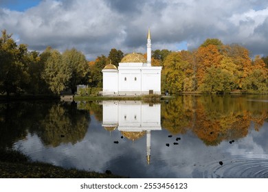 The building of a white mosque on the shore of a lake, reflecting in it - Powered by Shutterstock