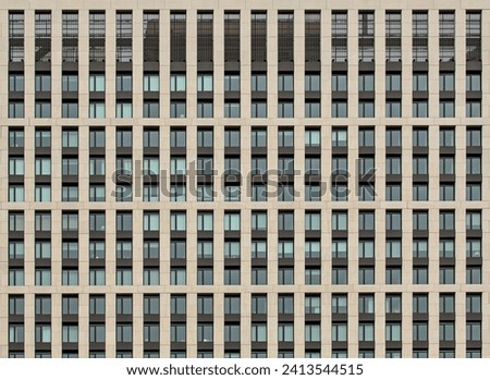 building window detail (grid of windows in modern residential building, apartment complex, coop, condo, condominium) abstract symmetrical pattern in housing flats, perpendicular lines intersecting