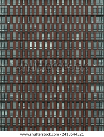 building window detail (grid of windows in modern residential building, apartment complex, coop, condo, condominium) abstract symmetrical pattern in housing flats, perpendicular lines intersecting