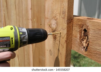 Building A Wooden Fence With A Drill And Screw