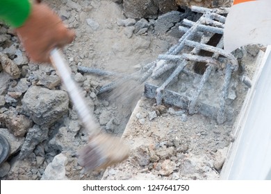 Building Worker Hitting With Sledge Hammer. Home Repair Concept