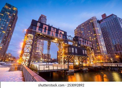 the buildings of long island in front of east river at twilight