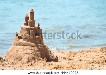 Built House sand castle with towers on the south shore of the sandy beach blue sea 