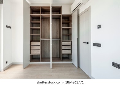 Built-in empty wardrobes with open doors. New house, empty rooms.  - Shutterstock ID 1864261771