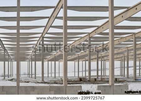 A built-up factory hall in winter. Worksite during winter. The concept of the finish of the project season and the end of construction work before winter.