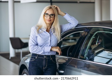 Buisness Woman Choosing A Car In A Car Showroom