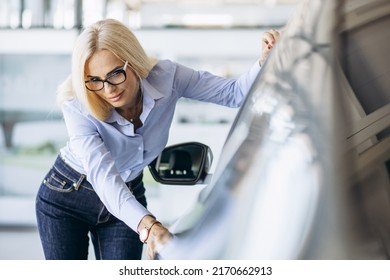 Buisness Woman Choosing A Car In A Car Showroom