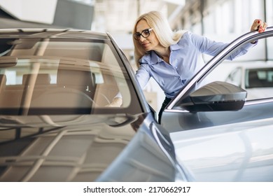 Buisness Woman Choosing A Car In A Car Showroom