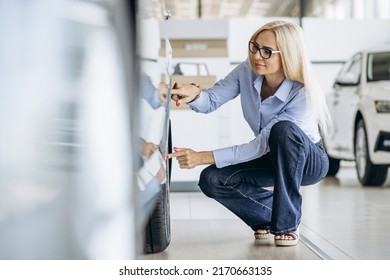 Buisness Woman Choosing A Car In A Car Showroom