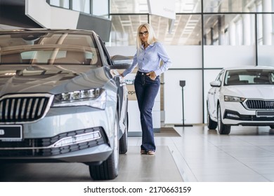 Buisness Woman Choosing A Car In A Car Showroom