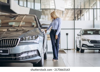 Buisness Woman Choosing A Car In A Car Showroom