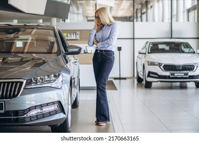 Buisness Woman Choosing A Car In A Car Showroom