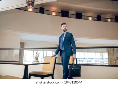 Buisnessman In A Blue Suit With A Black Suitcase