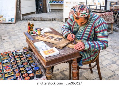 Bukhara, Uzbekistan - April 16 2014: A craftsmen in the Taqi Sarrafon market in the old city center