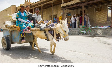 BUKHARA, UZBEKISTAN - JUNE 7, 2011: Unidentified Uzbek people ride a carriage with a donkey in Uzbekistan, Jun 7, 2011.  81% of people in Uzbekistan belong to Uzbek ethnic group