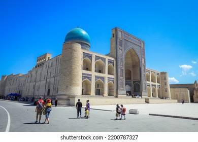 Bukhara, Uzbekistan - May 12, 2022: View To The Medieval Architectural Ensemble Poi Kalyan With Tourists In Bukhara