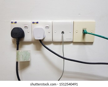 Bukit Mertajam, Penang. Sept 24 2019. Switch Socket Outlet, Plug Three Pin,  Ethernet Outlet And Cable On The High Wall.