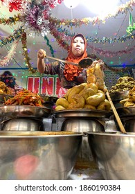 Bukittinggi, Indonesia - November 24, 2020:a Woman Selling Nasi Kapau Is Taking Orders For Costumers