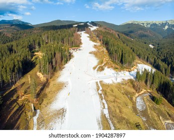 Bukovel Aerial View of the Ski Resort in Mountains With Artifical Snow at Low Season in Bukovel. Warm weather Without Snow. Ski Track in Early Winter