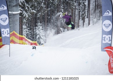 BUKOVEL,UKRAINE-20 MARCH,2018: Snowboard Contest In Winter Park.Young Athletes Compete In Snowboarding.Cool Extreme Sport Competition For Youth.Rider Performas Backflip Trick On High Speed