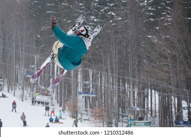 BUKOVEL,UKRAINE-24 MARCH,2018: Extreme Sport Competition In Winter Ski Park.Young Athletes Compete In Stunt Skiing.Rider Performas Barrelr Roll Backflip Trick High In The Air